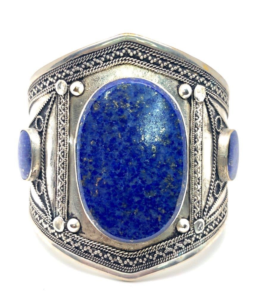 Lapis Lazuli Bangle Bracelet – Brass Cuff with Natural Blue Gemstone: Elevate your style with this amazing lapis lazuli bangle bracelet, featuring a bold brass cuff adorned with deep blue natural lapis lazuli. The rich hues of the stone, often flecked with golden pyrite