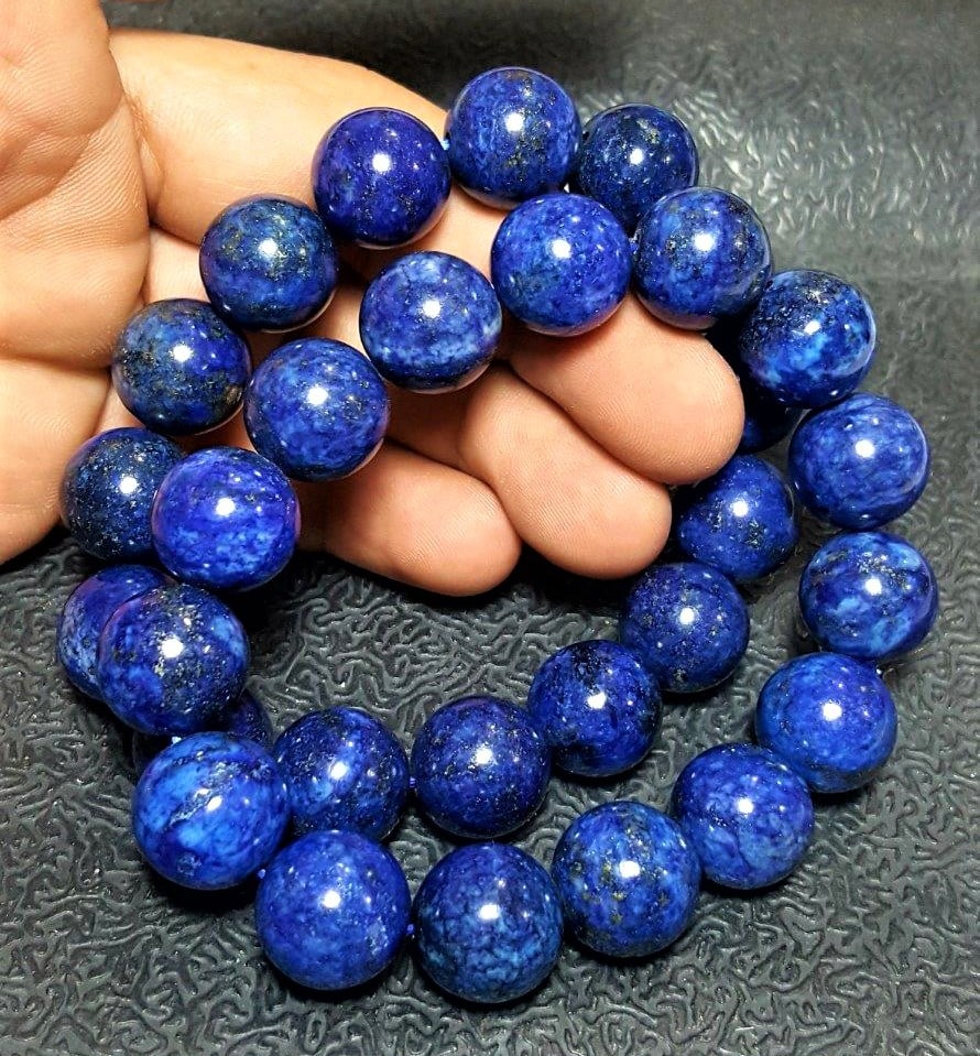 Paired Lapis Lazuli Bracelets - 14 mm Beads Size: Paired Lapis Lazuli Bracelets - 14 mm Beads SizeShipping Rate: $23.00 .shipping rates are determined by Parcel weight and destination.Combined shipping: We offer combine shipping on multiple items pur