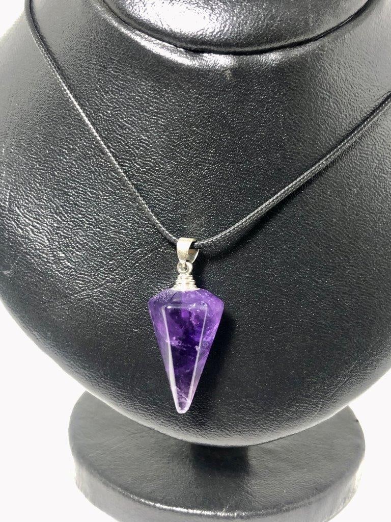 Carved Amethyst Pendant in Sterling Silver – Hand-Carved Purple Gemstone: This striking carved amethyst pendant showcases a richly colored natural amethyst, expertly hand-carved to highlight the gemstone’s depth and brilliance. The intricate detailing enhances the stone��