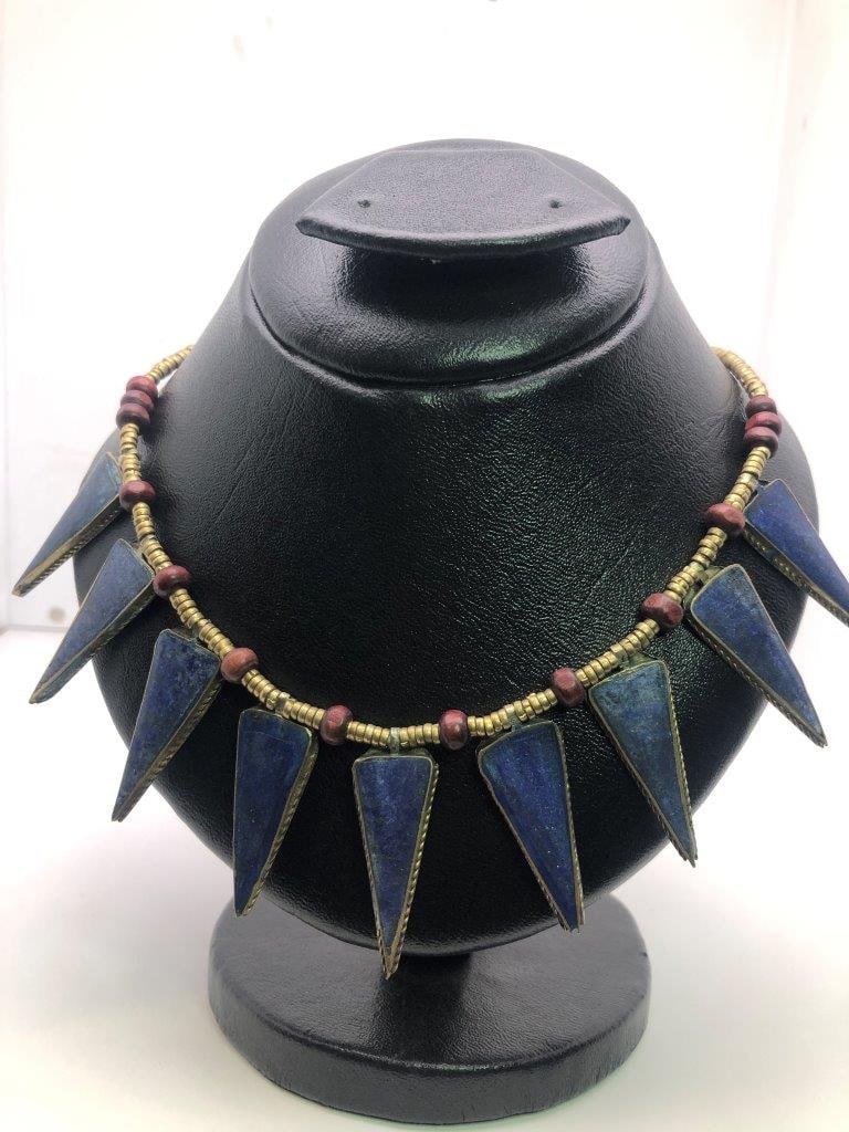 Brass Hand Carved Lapis Lazuli Necklace: an elegant hand carved lapis lazuli necklace showcasing the rich royal blue coloration for which this gemstone is prized. The stone displays natural variations and may show subtle pyrite inclusions, a