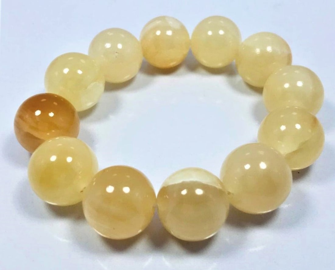 Honey calcite bracelet light brownish - 82.9G: Honey calcite bracelet light brownish and off white color - 17mm - 82.9G Shipping: $23.00. Shipping rates are determined by Parcel weight and destination.