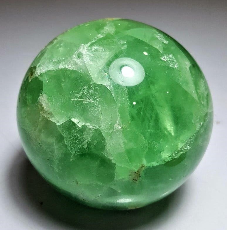 760 Grams Emerald Green Fluorite Sphere: 760 Grams Emerald Green Fluorite Sphere - Diameter 78 mmShipping Rate: $65.00 .shipping rates are determined by Parcel weight and destination.Combined shipping: We offer combine shipping on multiple i