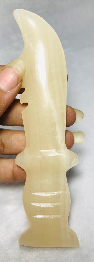 Honey Calcite Knife - 77.6G: Honey Calcite Knife - 137X27mm - 77.6G Shipping: $23.00. Shipping rates are determined by Parcel weight and destination.