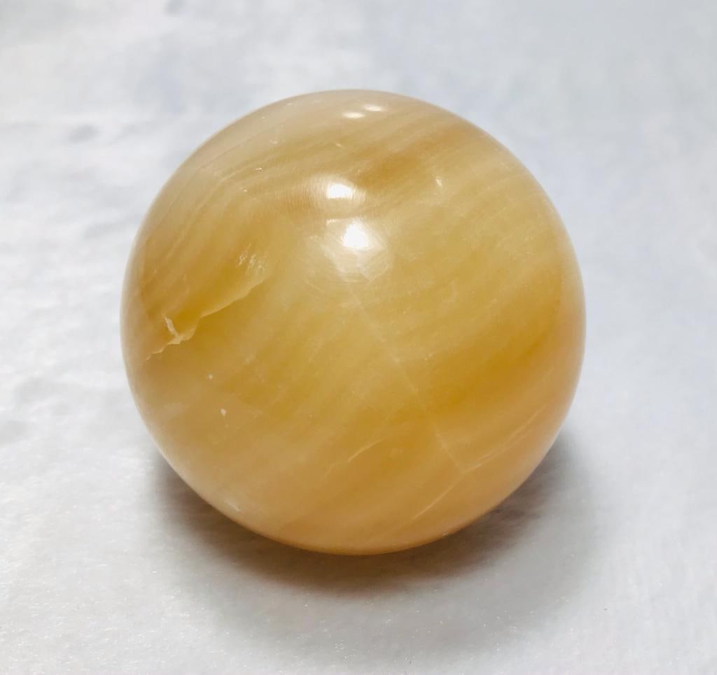 Polished Honey Calcite ball round shape - 365G: Polished Honey Calcite ball round shape - Diameter 63mm - 365G Shipping: $45.00. Shipping rates are determined by Parcel weight and destination.