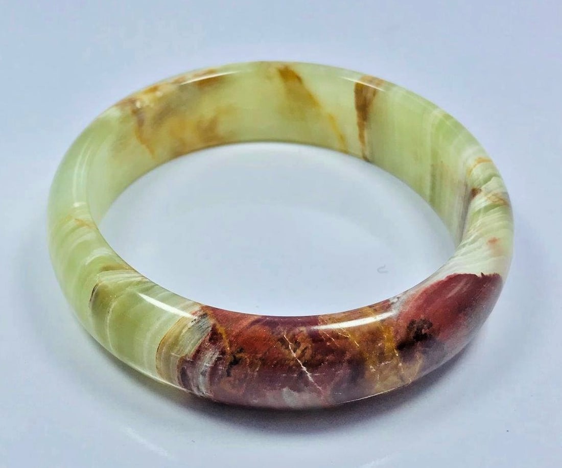 Onyx Beautiful hand bangle light green mix 67G: Onyx Beautiful hand bangle light green mix red color - 77.5mm - 67G Shipping: $23.00. Shipping rates are determined by Parcel weight and destination.