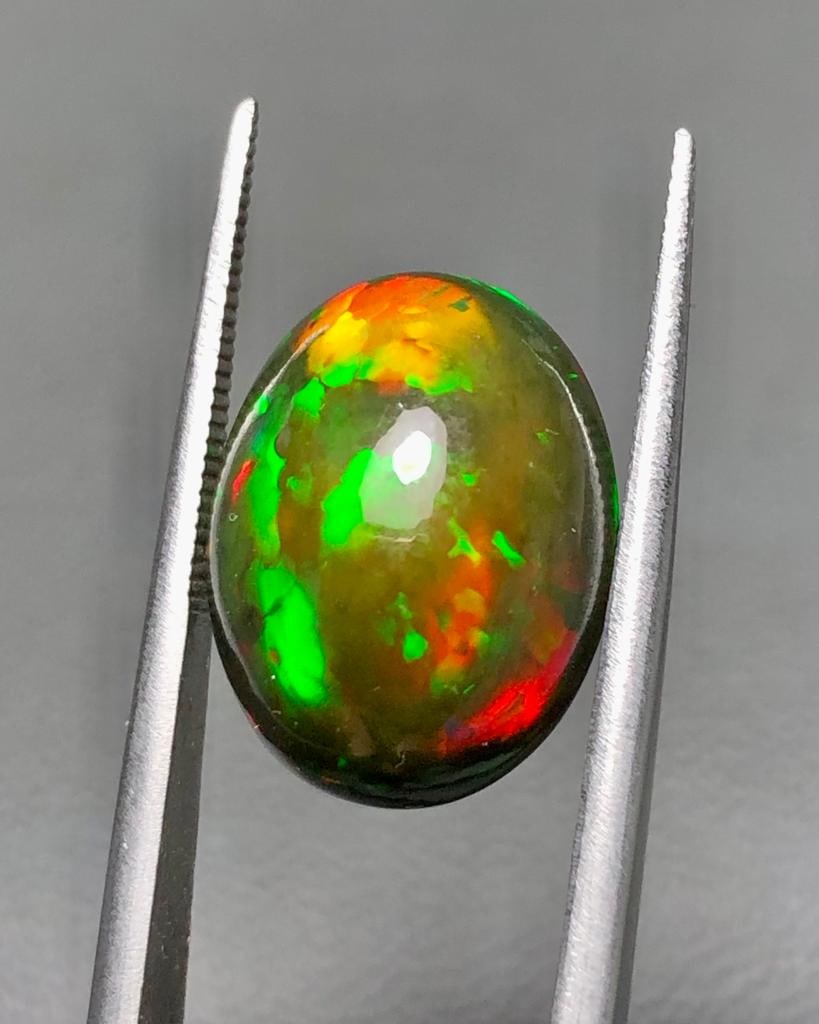 6.45 Carats AAA Quality Natural Fire Black Opal - 15X12X7 mm: 6.45 Carats AAA Quality Natural Fire Black Opal - 15X12X7 mmShipping Rate: $15.00 .shipping rates are determined by Parcel weight and destination.Combined shipping: We offer combine shipping on multip
