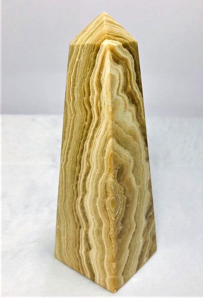 Layered Choclate Calcite point tower - 644.2G: Layered Choclate Calcite point tower - 155X51mm - 644.2G Shipping: $60.00. Shipping rates are determined by Parcel weight and destination.