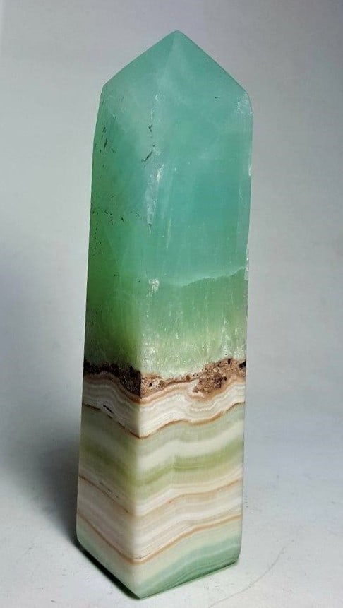 Pistachio Calcite Tower - 420 Grams: Pistachio Calcite Tower - 420 Grams - 142X31X30 mmShipping Rate: $45.00 .shipping rates are determined by Parcel weight and destination.Combined shipping: We offer combine shipping on multiple items