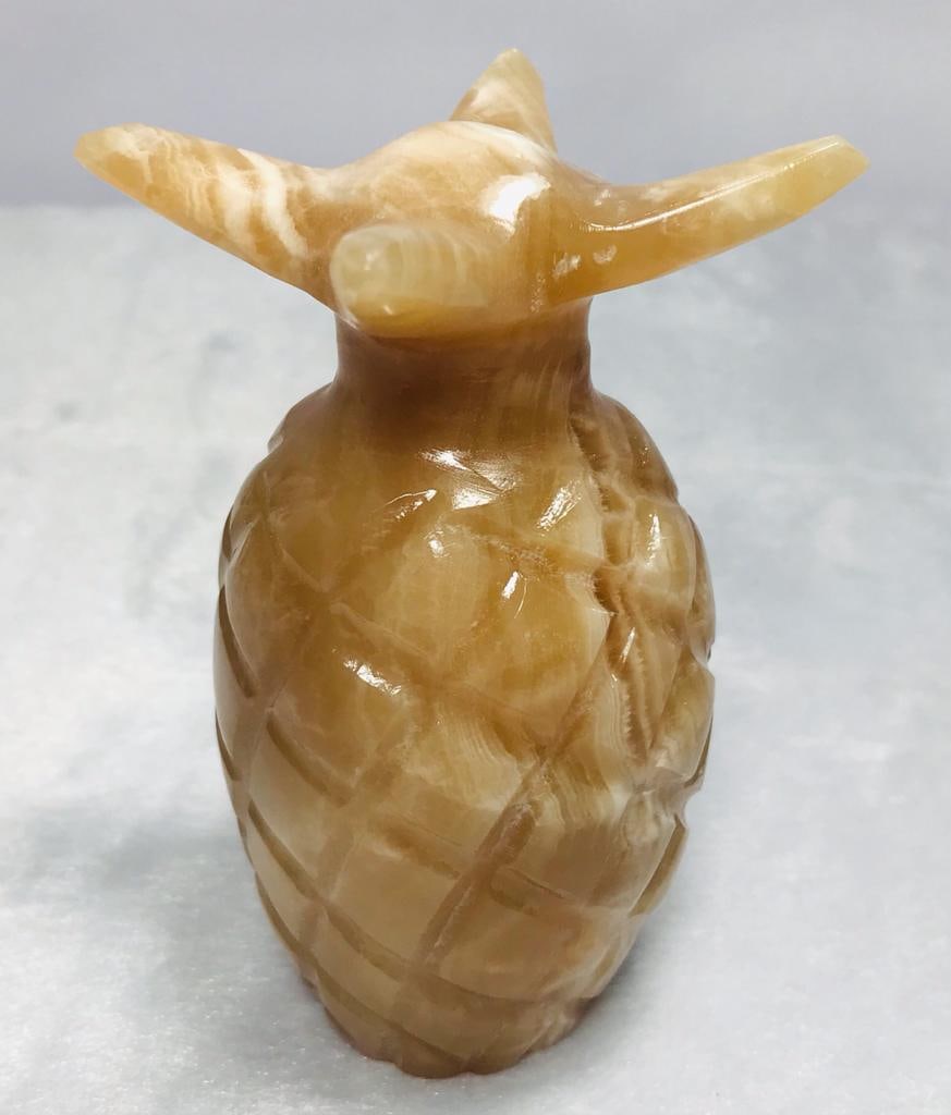 Calcite stone table decoration pineapple 434.3G: Decorative calcite stone table decoration piece of pineapple honey color - 105.5X55mm - 434.3G Shipping: $45.00. Shipping rates are determined by Parcel weight and destination.