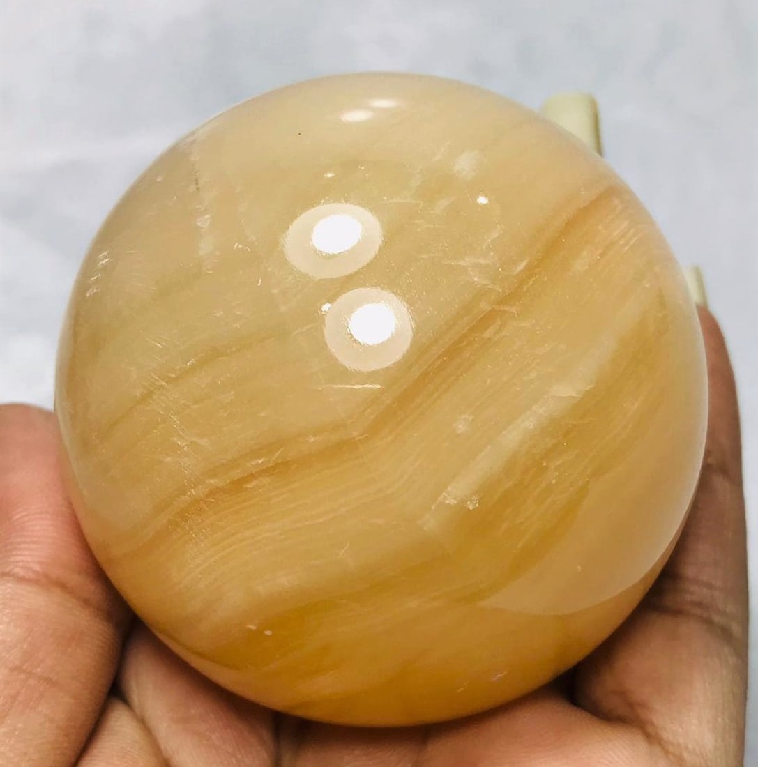 Honey Calcite Sphere - 346.6 Grams: Honey Calcite Sphere - Diameter 62mm - 346.6 Grams Shipping: $45.00. Shipping rates are determined by Parcel weight and destination.
