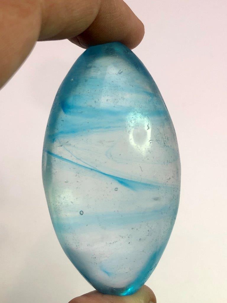 Carved Natural Glass Healing Egg with Blue Inclusions ? 150 g Polished Crystal Egg | Decorative: This stunning hand-carved natural glass healing egg weighs 150 grams and features beautiful blue inclusions suspended inside the translucent glass. The smooth, polished egg shape highlights the intern