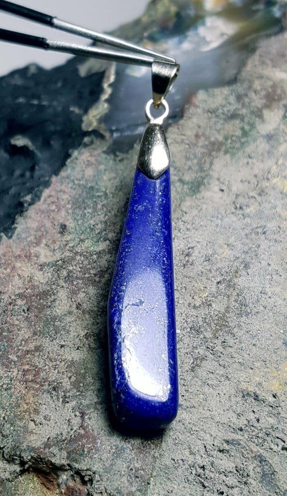 Long Lapis Pendant: Long Lapis Pendant - 41X9X8 mm Shipping: $23.00. Shipping rates are determined by Parcel weight and destination.