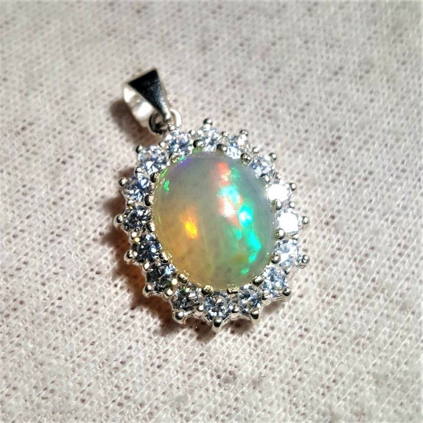 Sterling Silver White Opal Pendant With ZirCons: Sterling Silver White Opal Pendant With ZirConsShipping Rate: $23.00 .shipping rates are determined by Parcel weight and destination.Combined shipping: We offer combine shipping on multiple items purc