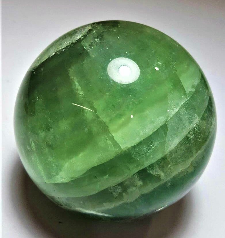 719 Grams Healing Fluorite Sphere: 719 Grams Healing Fluorite Sphere - Diameter 74 mmShipping Rate: $65.00 .shipping rates are determined by Parcel weight and destination.Combined shipping: We offer combine shipping on multiple items p