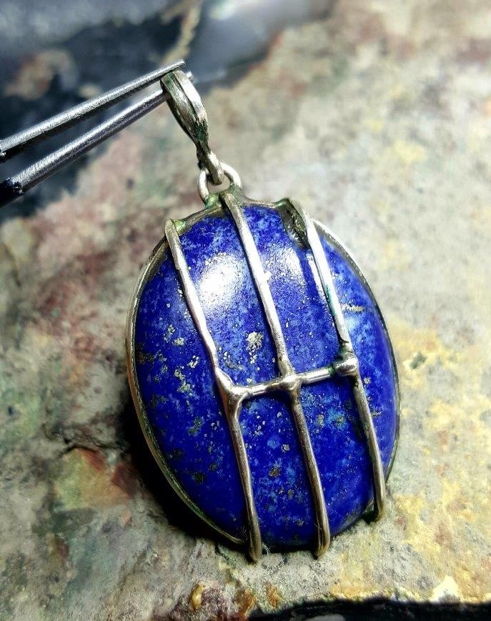 Wire Wrapped Lapis Silver Pendant: Wire Wrapped Lapis Silver Pendant - 39X27X9 mmShipping Rate: $23.00 .shipping rates are determined by Parcel weight and destination.Combined shipping: We offer combine shipping on multiple items purch