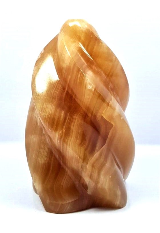 Honey Calcite Flame - 659.7 Grams: Honey Calcite Flame - 659.7 Grams - 112X70X64 mmShipping Rate: $55.00 .shipping rates are determined by Parcel weight and destination.Combined shipping: We offer combine shipping on multiple items pur