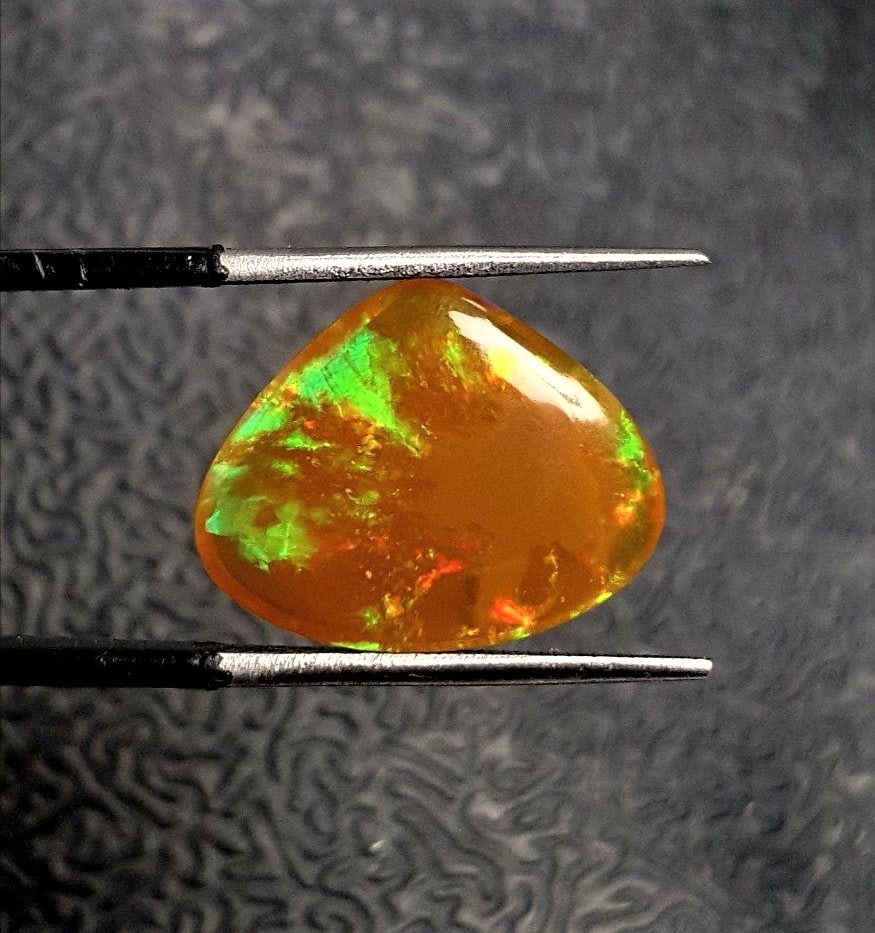 Fire Opal Ethopian - 6 Carats: Fire Opal Ethopian - 6 CaratsShipping Rate: $15.00 .shipping rates are determined by Parcel weight and destination.Combined shipping: We offer combine shipping on multiple items purchased to reduce sh