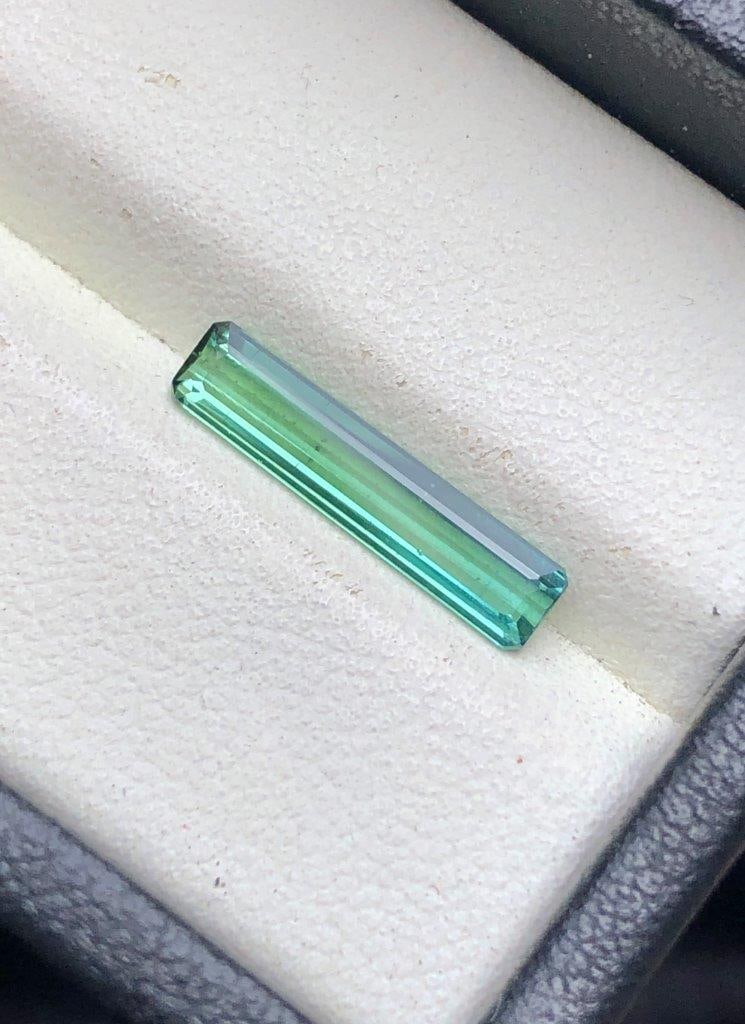 1.50 Carats Greenish Tourmaline Gemstone ? Natural Long Cut Loose Stone 17x4x3 mm: Elegant 1.50 carats natural greenish Tourmaline gemstone featuring a beautiful soft green hue, fine clarity, and attractive natural brilliance. Measuring 17x4x3 mm, this uniquely elongated cut loose g