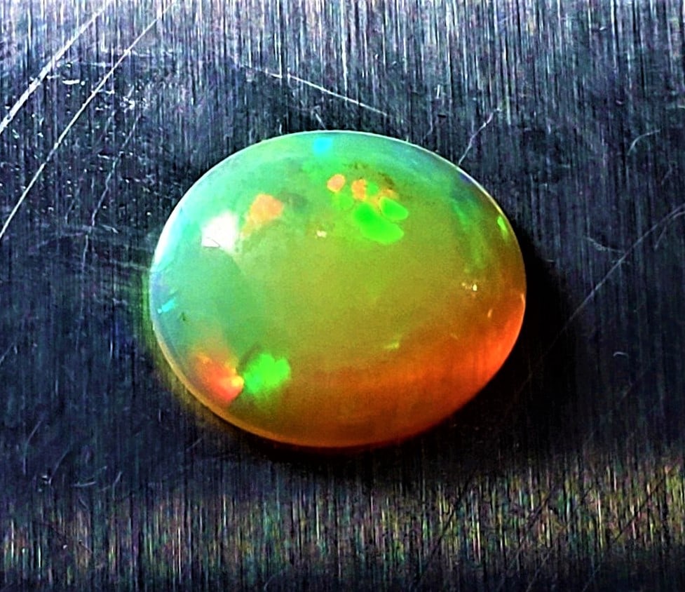 Fire Ethopian Opal Oval Shape - 2.5 Carats: Fire Ethopian Opal Oval Shape - 2.5 Carats - 12X11X4.5 mmShipping Rate: $15.00 .shipping rates are determined by Parcel weight and destination.Combined shipping: We offer combine shipping on multiple 