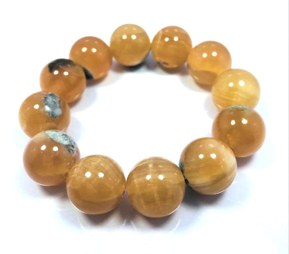 Honey calcite bracelet - 91.8 Grams: Honey calcite bracelet - 17.5mm - 91.8 Grams Shipping: $23.00. Shipping rates are determined by Parcel weight and destination.