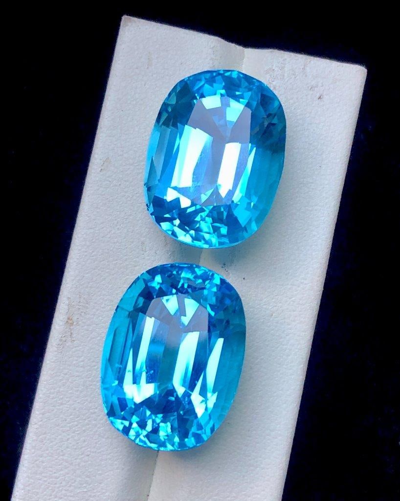 86.40 Cts Paired Swiss Blue Topaz Gemstones ? Natural Loose Pair 23x17x14 mm: Stunning 86.40 carats paired natural Swiss Blue Topaz gemstones featuring a vibrant sky-blue color, excellent clarity, and brilliant sparkle. Measuring 23x17x14 mm, this matched pair is perfect for cu