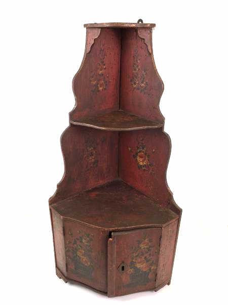 Decorative Chinese Miniature Cupboard: Decorative Chinese small hanging wooden wall corner cabinet, painted red, 2 shelves, lower cabinet, no key, floral motif with 2 baskets of roses on each door, damage to one side of door, damage to low