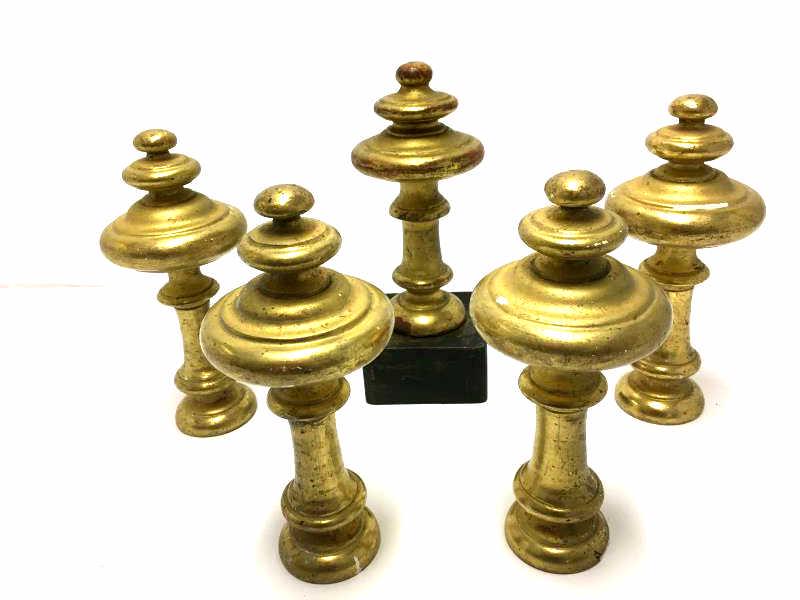 5 Wooden Finials: 5 Newell Posts, wooden, painted gold, worn with paint loss, one is on a square base that measures 9 1/2" h, 4 are 8 1/2" h
