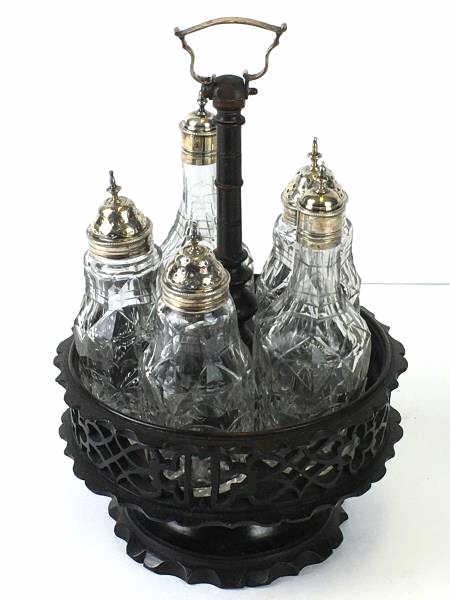 Cruet Set in revolving wooden rack: Cruet Set - 5 Glass Bottles with plated silver tops, in mini wooden revolving rack, tallest cruet is 6" h, overall height in stand 10", touch mark on top arrow with armored fist