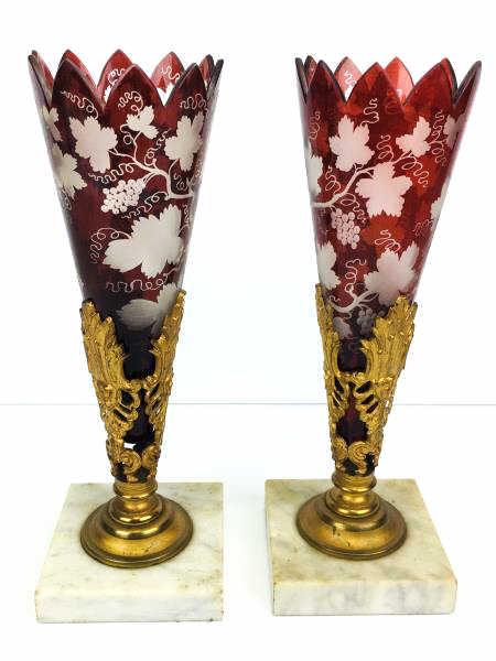 Pair of Cranberry Glass Vases with 3 face painted gold: Pair of Cranberry Glass Fluted Vases, etched leaf and grape, one glass is chipped, insert on marble stand, 3 painted gold face holder, 11" h with 4" square marble base, (dirty)