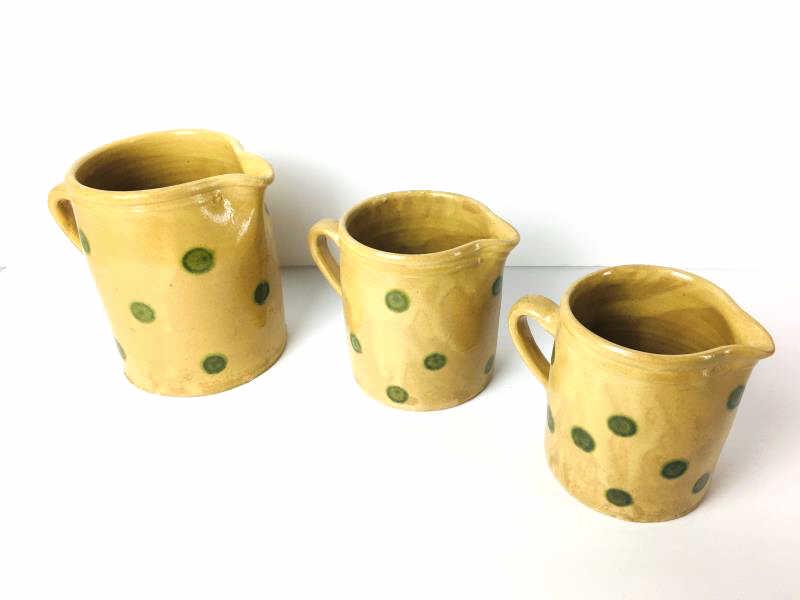 3 Graduated Pitchers: 3 Pitchers, made in France, tan with green dots, 6 1/2" h and 5" h and 4 1/2" h