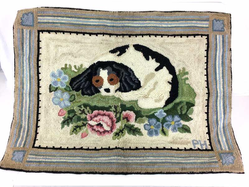 Modern Dog Needlework Rug: Needlework Rug, modern, dog lying in bed of flowers, initialed lower right PH, ready to hang, partial label on back "Made in USA, Pat Hornafius 1990," 24" x 32"