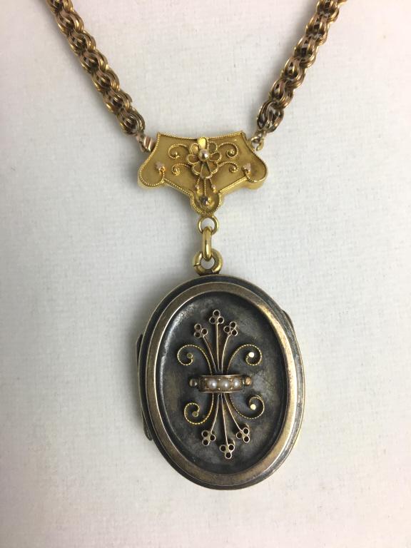 Locket on Chain: oval, inscribed "To Madeline from Mary 1928," inside glass frame, scrolled inside "MCMC".lower side clasp, 1 1/4" x 1 1/2" locket, 16 1/2" l