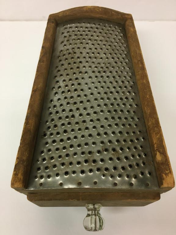 Wooden Table Grater: pierced tin top, one drawer, slanted, dovetailed, 12 1/2" l x 5" h to 3 1/4" high, glass pull is chipped