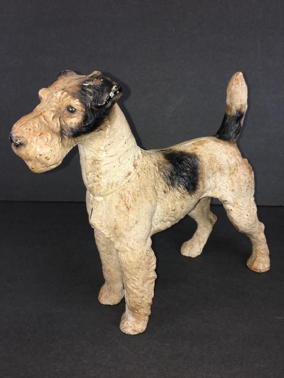 Cast Iron Dog Doorstop: Fox Terrier, felt cushion on bottom of 4 paws, nose to tail 10" l x 9" leg to leg and 10" h small crack on head, some paint loss and rust