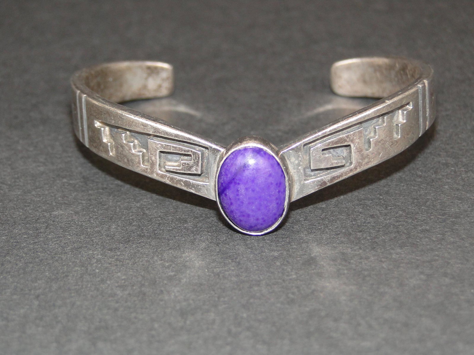 Sterling Navaho EMT Cuff Bracelet: Everett Mary Teller, stamped EMT in fish design with bezel set purple agate 9 x 12, minor surface scratching, 1/2" wide, 4 3/4" inside measurement, slightly flexible