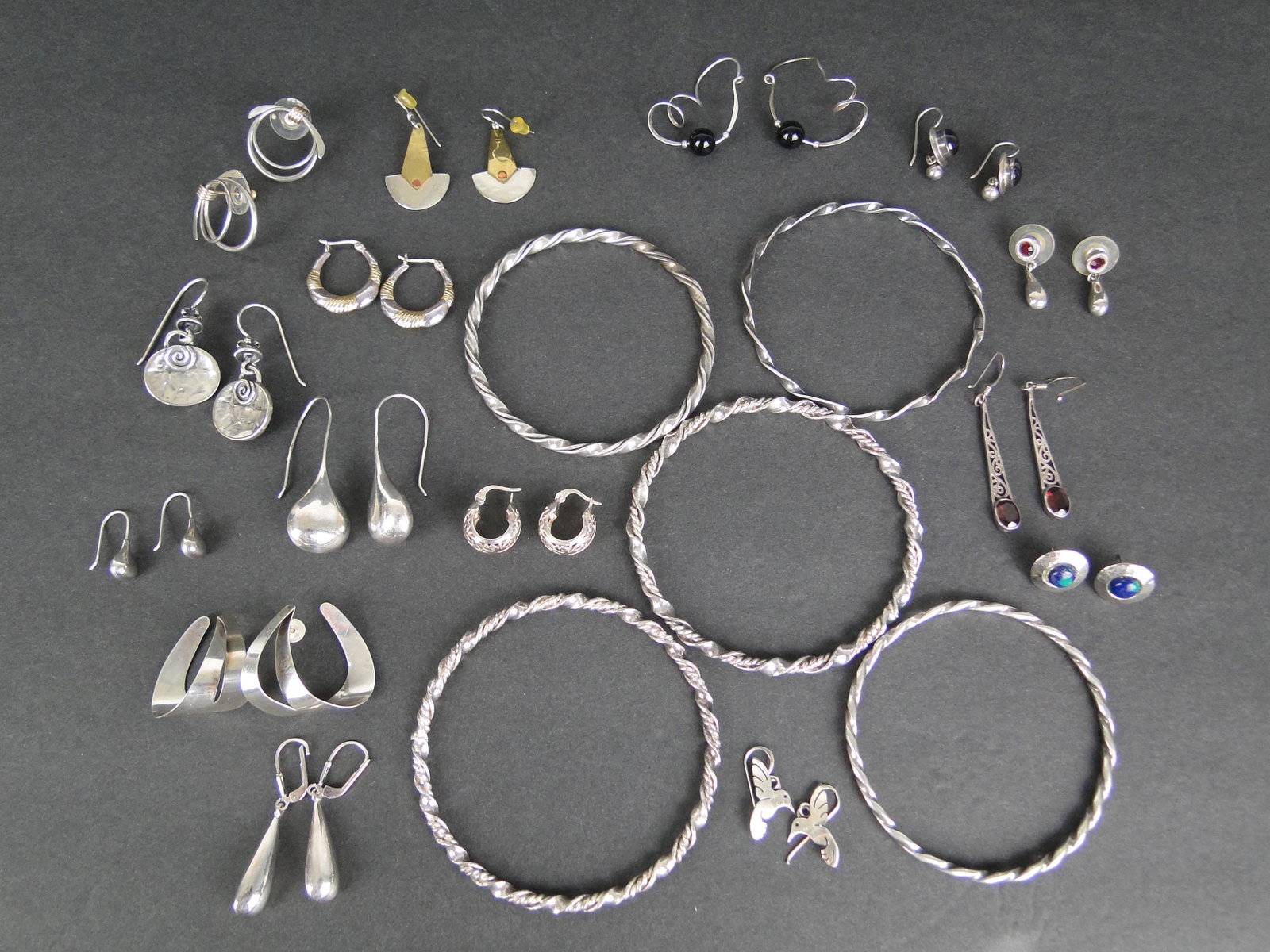 Lot of Earrings and Bangles: 15 pierced sterling earrings - 4 prs with stone, 1 pr w beads, 2 pr are two tone, 5 bangle bracelets, 3 bracelets are sterling (37.7 g) non-stone sterling weight is 26.1 g