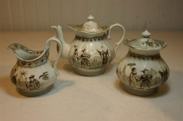 19th C English Child's Tea Set: 19th C English Child's Tea Set, Brown Transfer Ironstone, Oriental Children with floral border; 6 cups (1 cracked), 3 saucers, Teapot, Cream, Sugar, Waste, 1 Plate marked "BB New Stone"