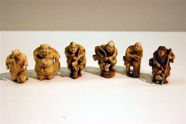 SIX CARVED ORIENTAL FIGURES, SIGNED