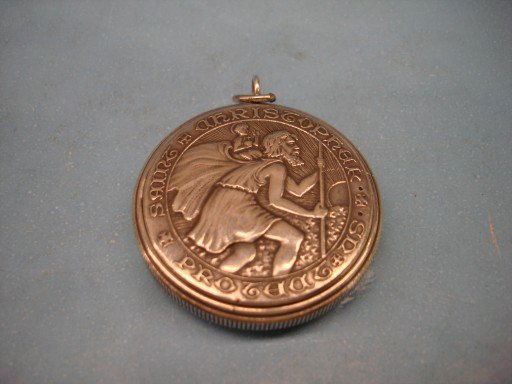 Sterling Movado Pocket Watch in Closed Case: Sterling Movado Pocket Watch in Closed Case with Religious Figure & Latin in Relief - 1 7/8" dia