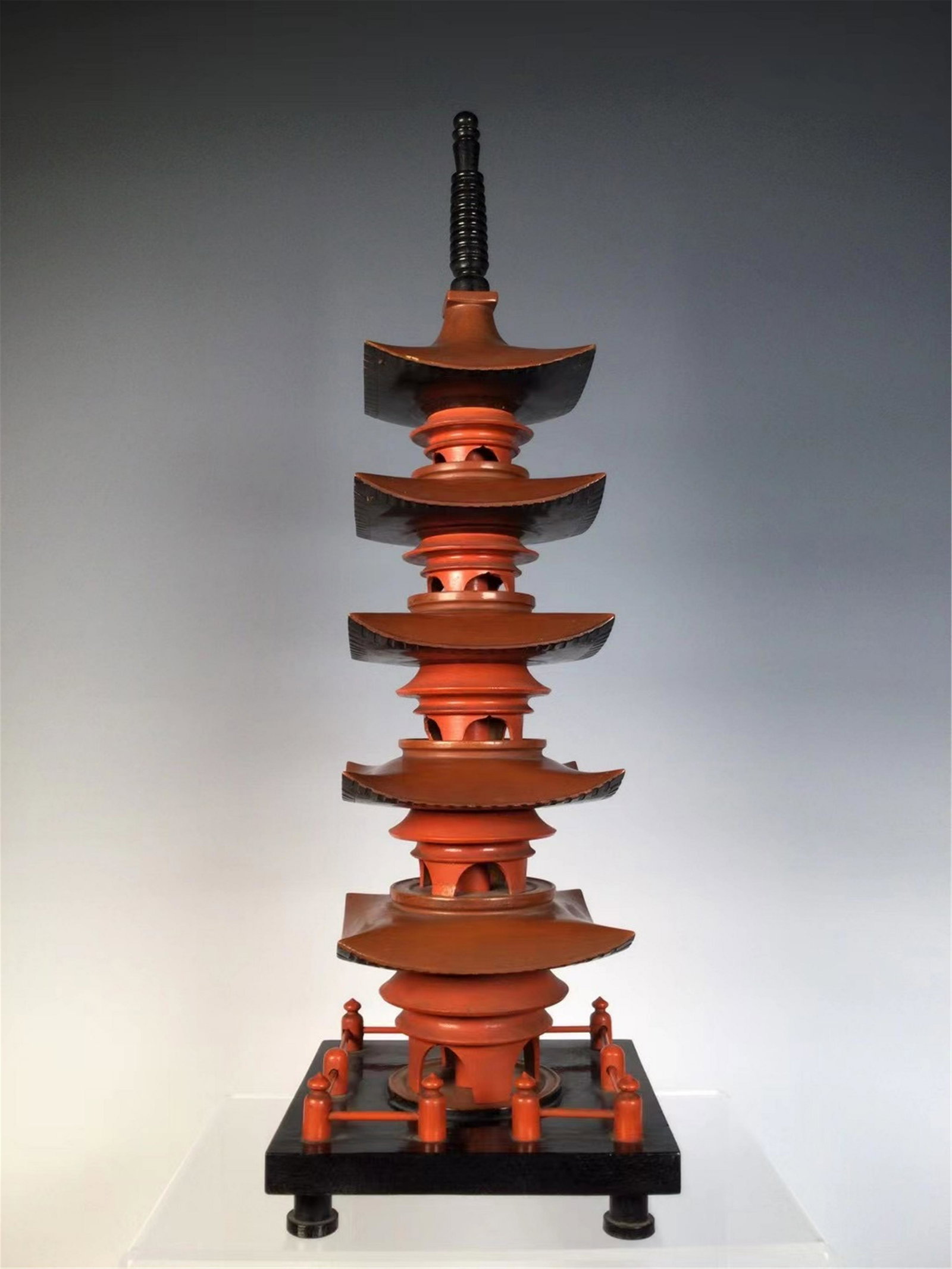 A LACQUERED WOODEN BUDDHIST PAGODA: H. 47 cm. L. 14.5 cm.