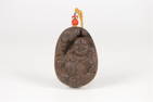 AN ALOESWOOD CARVED MAITREYA PLAQUE PENDANT