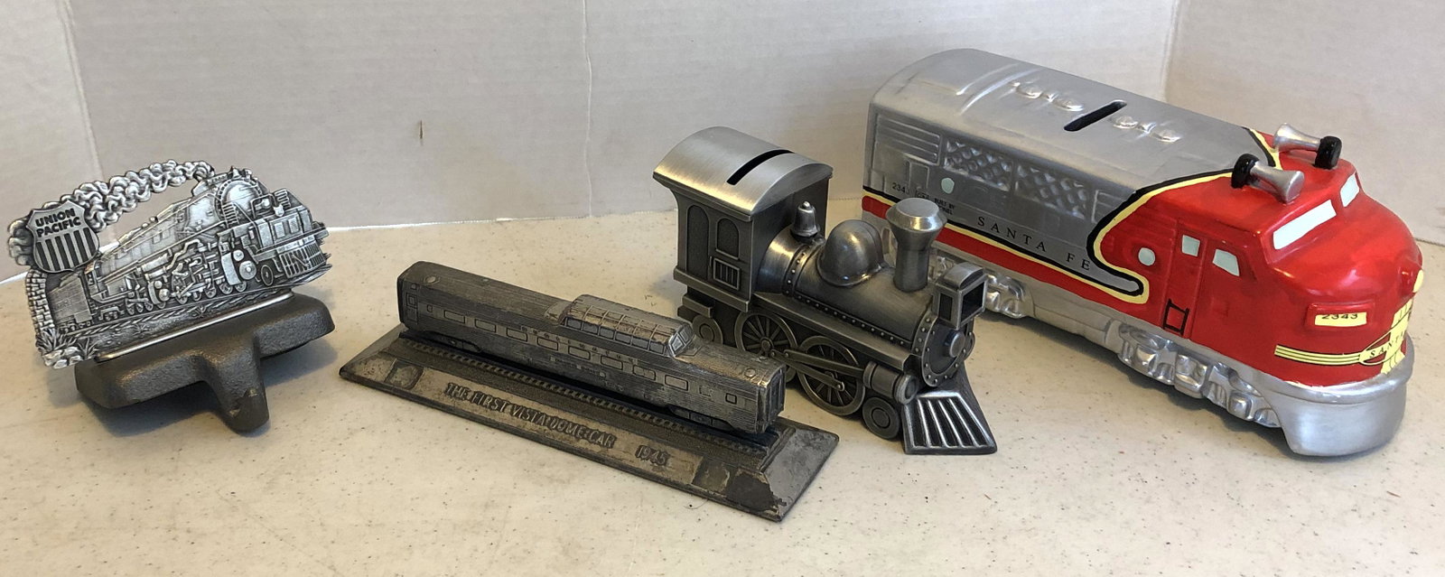 Group of Rarilroad Memorabilia Items: Lionel ceramic bank, Union Pacific RR Stocking Holder, Sheridan metal Bank, Pewter paperweight "The first Vista dome car 1945", 1983 Soo Line playing cards, Marbles