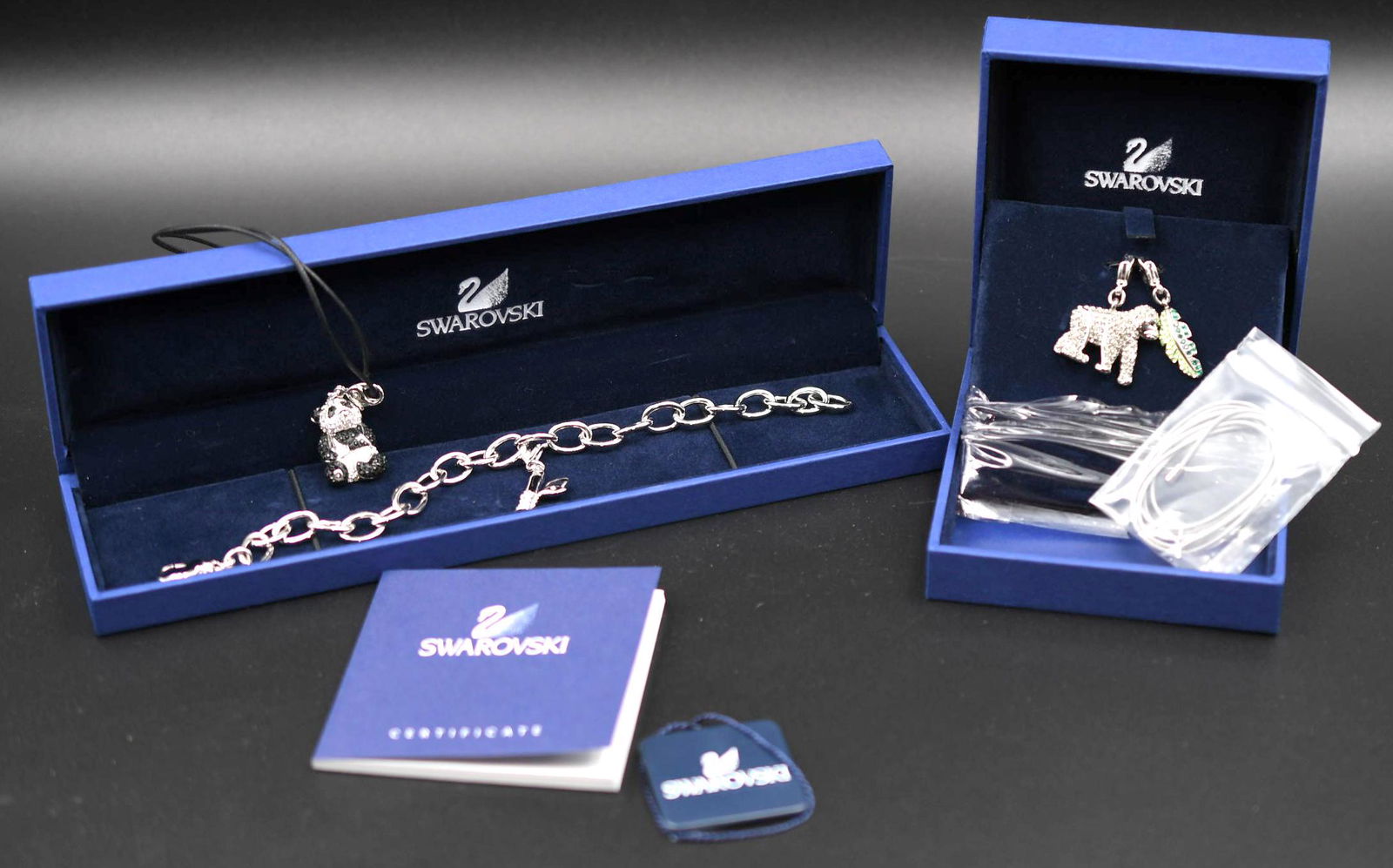 Swarovski Charm Bracelet: Includes 4 charms with orginal boxes and certificate, weighs 9oz