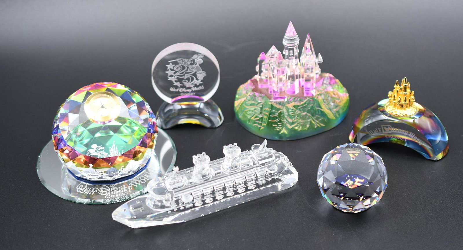 Disney Crystal Glass Souvenirs: 6 items plus mirror include cruise ship, clock, castle on mountain, castle on paperweight, 45th Disneyland celebration paperweight, Disney World 25th. Combined Weight is 2 lbs 12 oz