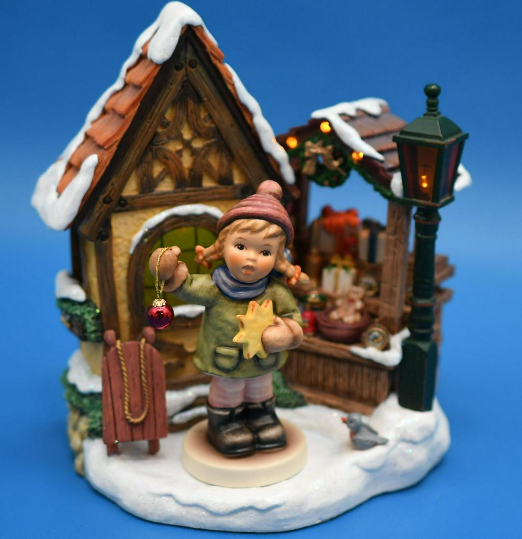 Hummel " Bavarian Christmas Market" W/Music box: no. 1098-D 2004, The market is resin and is 7" tall x 6" wide, 2 AA batteries "not included" light up the lamp, display area and window, also included is 4-1/8" tall Hummel Figurine "Holiday Fun" 2004