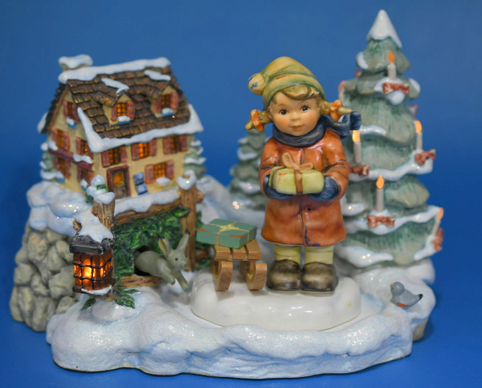 Hummel "Tidings of Joy" Limited Edition: No 1083-D 2003 resin structure measures 5-1/2" tall x 7-1/4" wide, it takes 2 AA batteries to light Christmas tree, windows & lantern and winds to play music. Includes 4-1/4" tall Exclusive edition Hu