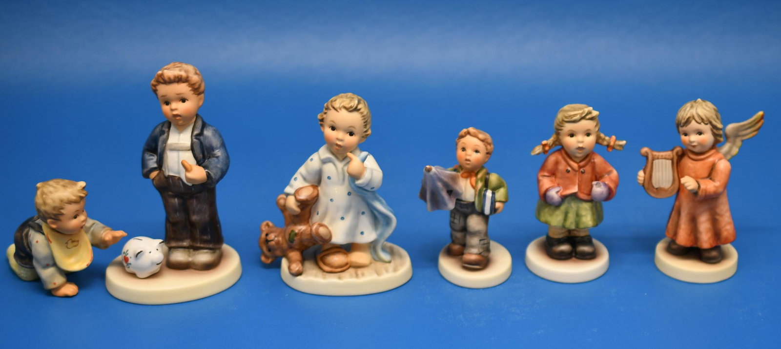 Hummel's "6 Original Hummels": Left to right 2-3/4" tall "2090/b", 4-7/8" "The Little Banker", 4" "No Bed Please", 3-1/4" "Is It Raining?, 3-3/4" "Wishing On A Star", 3-3/4" "Angel With Harp". Combined Weight is 1 lb