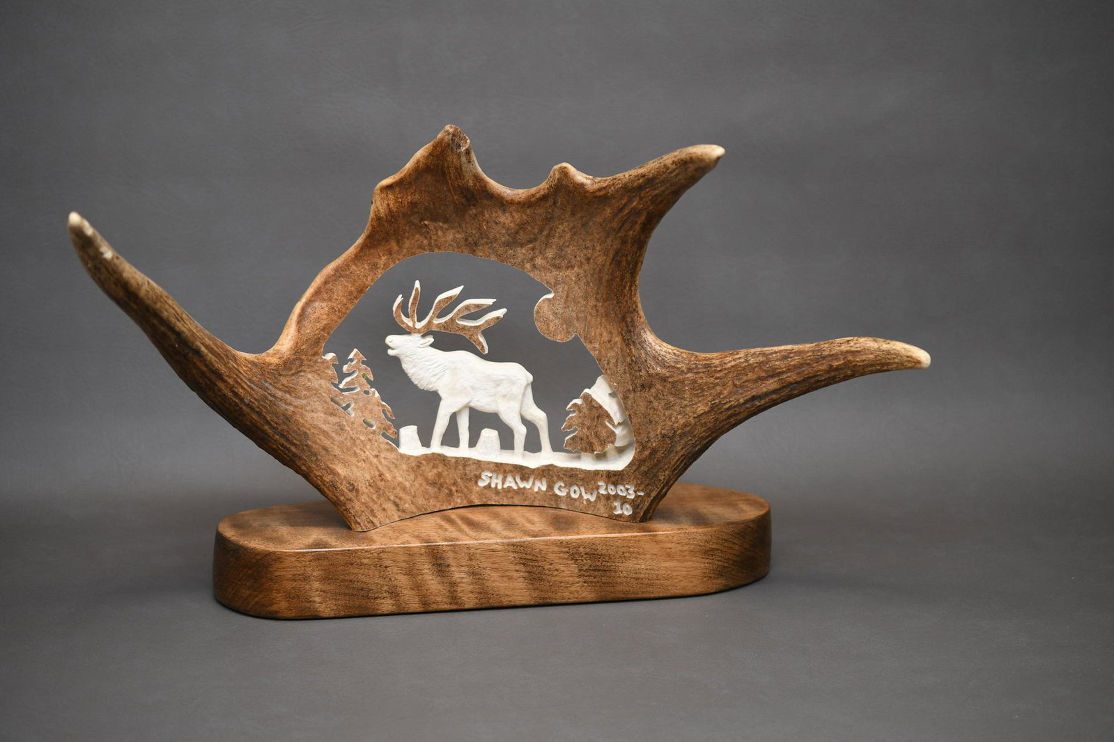 Carved Moose Antler inscribed Shawn Gow 2003 - 10: This antler is a 20" spread x about 12" and the carving is 8-1/2"x 5-1/2" and is mounted on what looks to me a birch slab of wood with felt on the bottom, weight is 6 lbs 6 oz