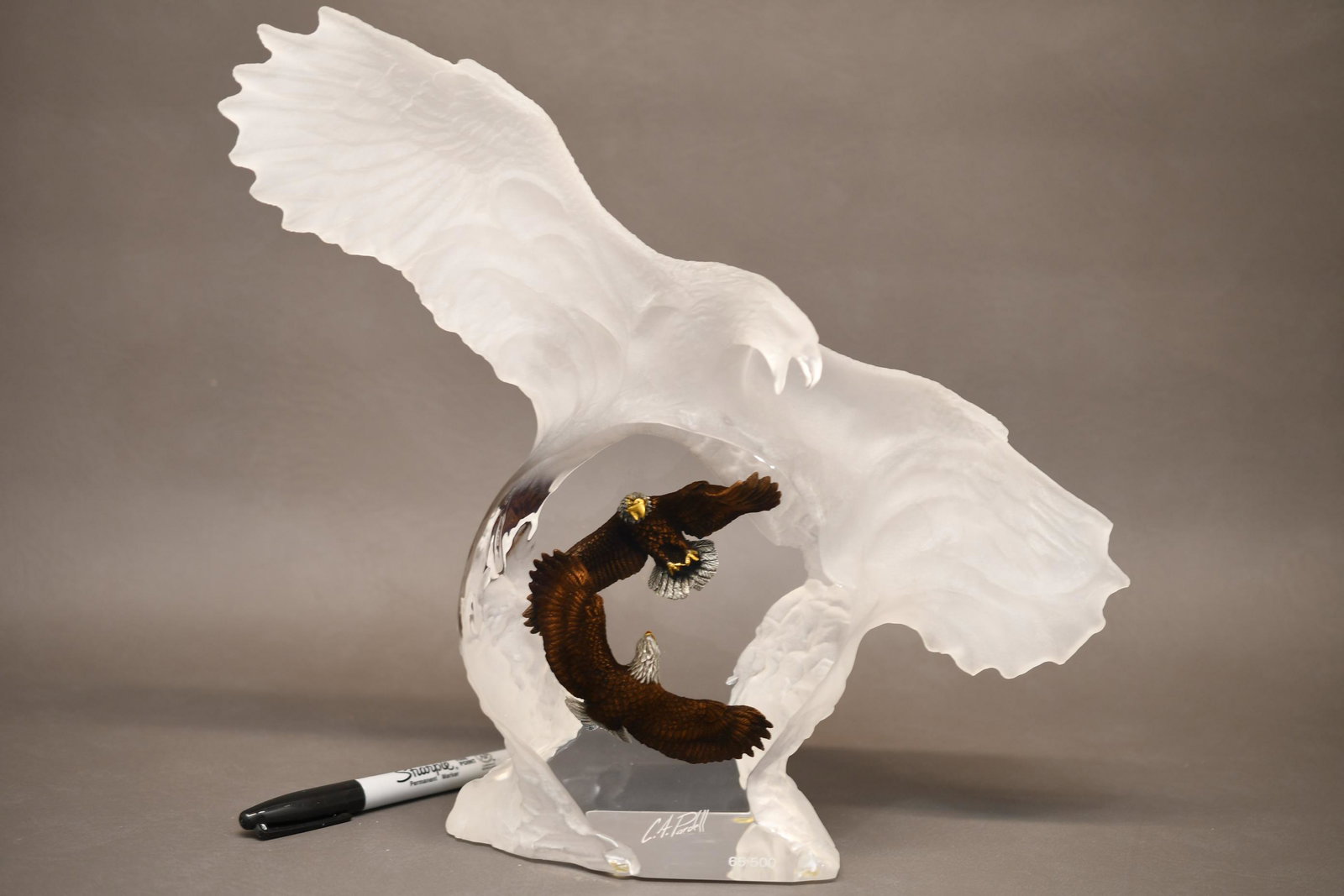Chris Pardell Eagle's in Battle Captured in a Lucite: Beautiful piece, the Lucite eagle wing span measures 15" and it's 12" to the highest point of the wing from the surface x 3" thick. Weighs 4 lbs 14 oz, includes certificate of ownership 65 of 500 made