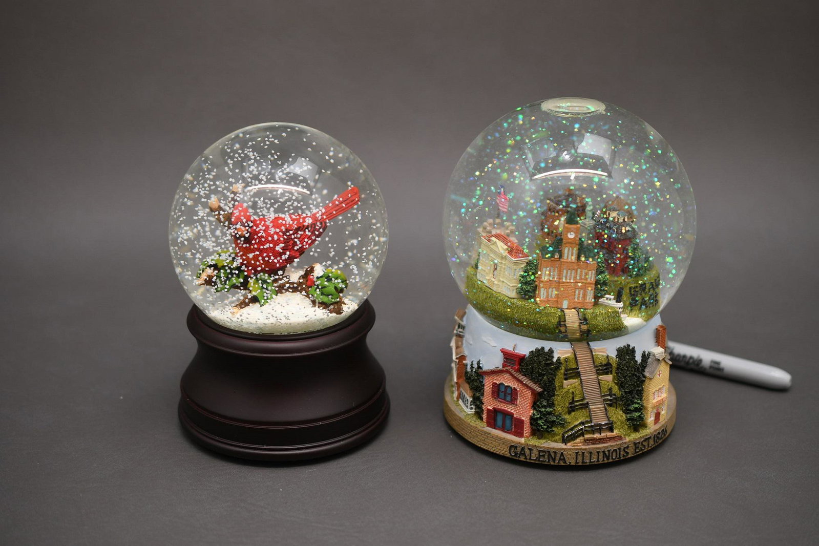 Two Musical snow globes: Cardinal globe by San Francisco Music Box Company 6" tall x 4" diameter, Galena Illinois globe by Three Jays Imports 6-1/4" tall by 4-3/8" diameter, approximate total weight is 4.5lbs